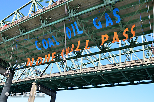 In July 2013, the climate action group Rising Tide hung a banner from the Interstate Bridge in Portland that read 'Coal, oil, gas, none shall pass.' (Photo: Adam Elliot/Portland Rising Tide; Flickr CC BY-NC-SA 2.0)